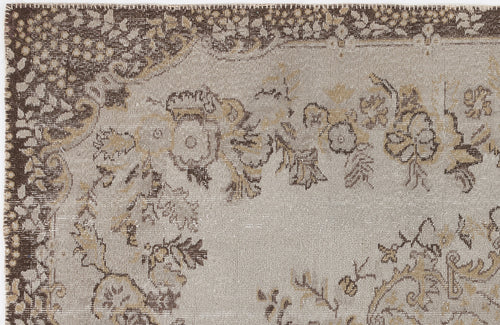 Load image 1 in gallery view. Taupe and brown distressed rug with a traditional floral medallion pattern and a decorative border.