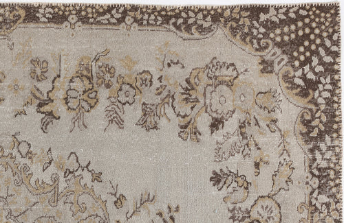 Load image 1 in gallery view. Beige and brown vintage-style rug with a distressed floral medallion pattern and a dark decorative border.