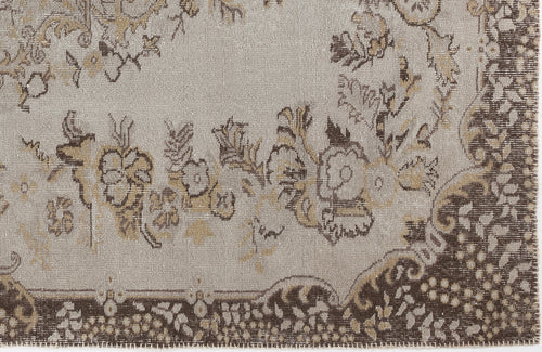 Load image 1 in gallery view. Taupe and brown rug with a distressed floral medallion pattern and a detailed decorative border.