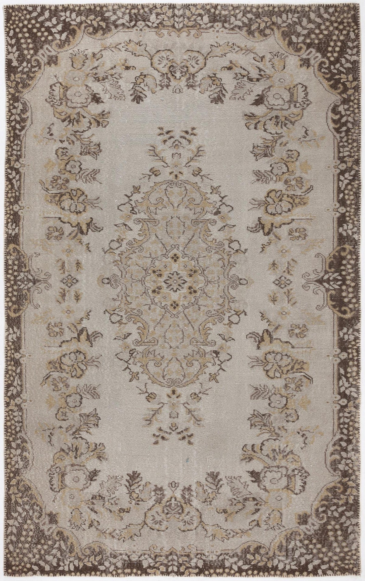 Beige and brown traditional rug with a central floral medallion and a decorative border.