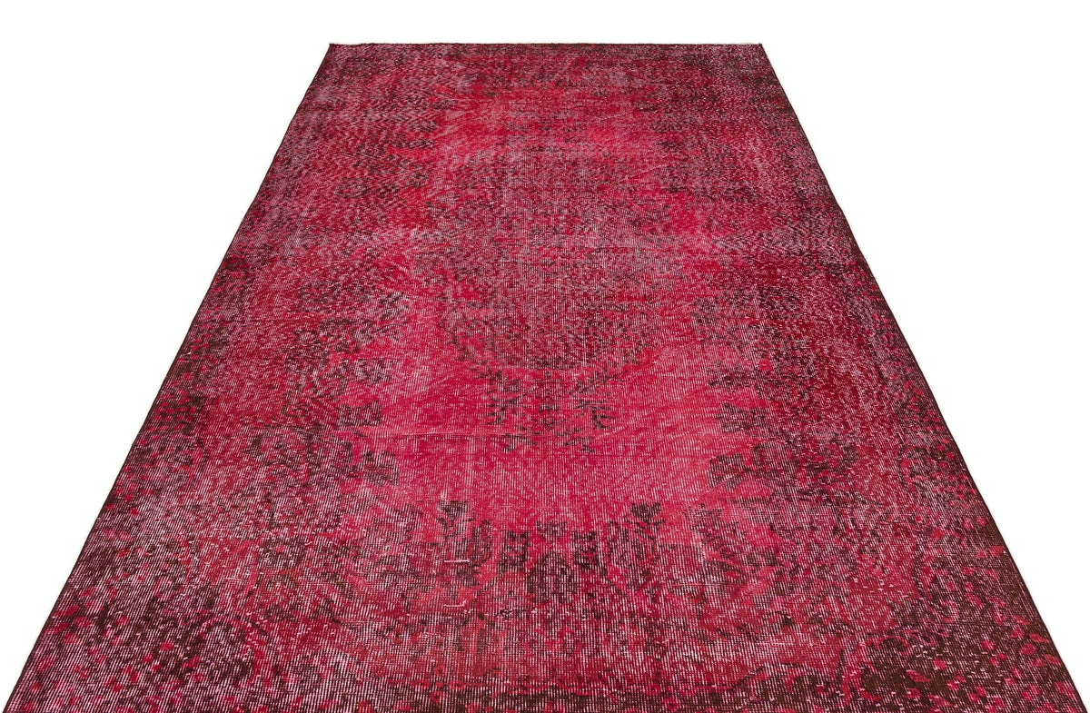 Deep red and black distressed vintage-style rug with a central medallion pattern on a white background.