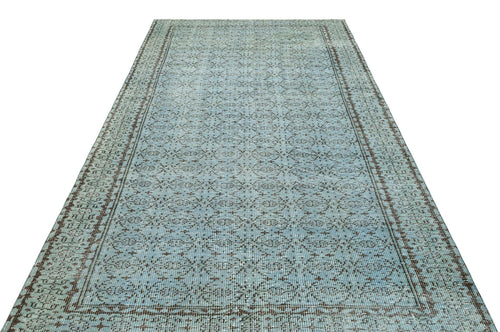Load image 1 in gallery view. Light blue and brown distressed runner rug with a repeating geometric medallion pattern and a bordered edge.