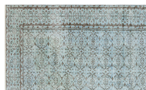 Load image 1 in gallery view. Light blue and brown distressed rug with a traditional repeating medallion pattern and a bordered edge.