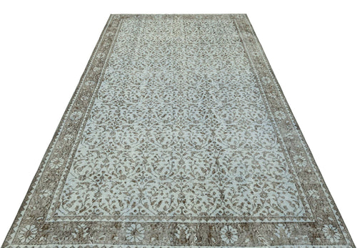 Load image 1 in gallery view. Light blue and brown vintage-style rug with an intricate floral medallion pattern and a wide decorative border.