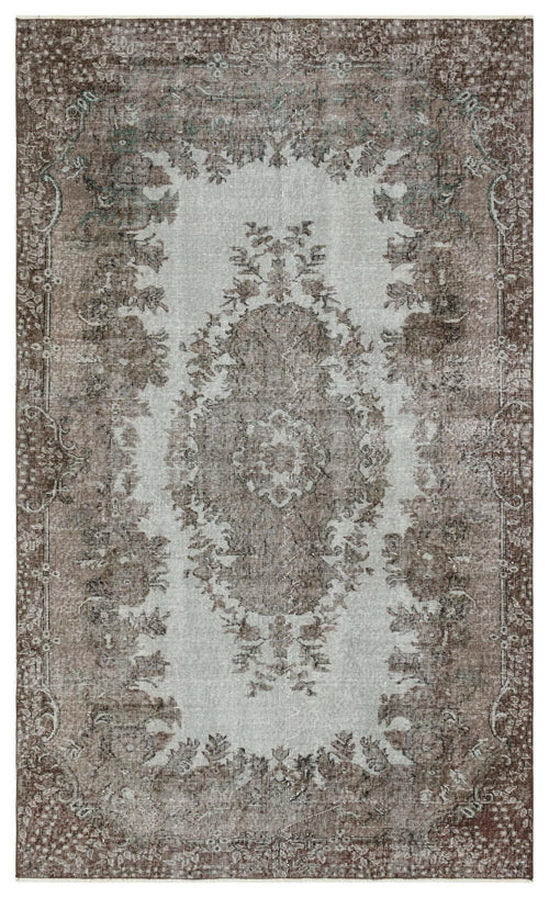 Load image 1 in gallery view. Distressed brown and light gray rug with a traditional central floral medallion and ornate border.