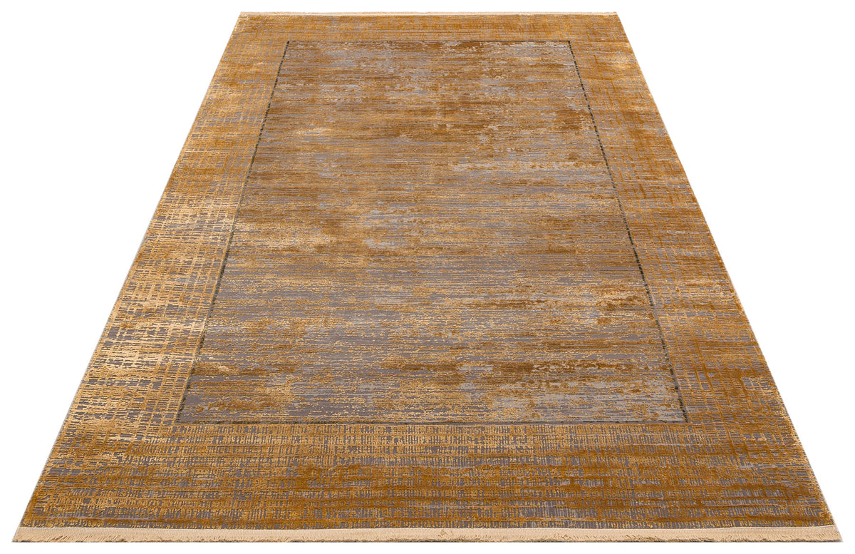 Ochre and grey distressed abstract rug with a bordered design and short fringe on a white background.