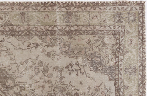 Load image 1 in gallery view. Distressed beige and brown rug with a traditional floral medallion pattern and geometric border.