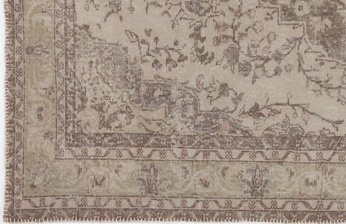 Load image 1 in gallery view. Taupe and beige distressed traditional rug with a faded floral medallion pattern and a geometric border.