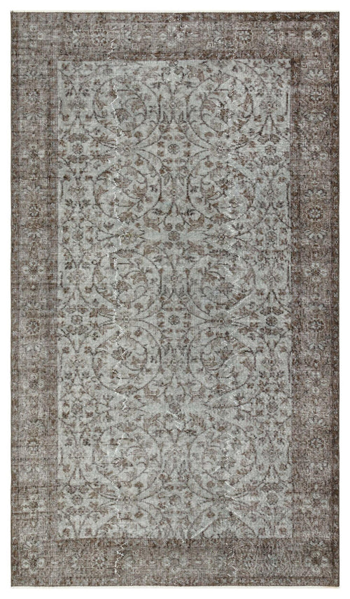 Load image 1 in gallery view. Distressed brown and grey rug with a traditional floral medallion pattern and a wide decorative border.