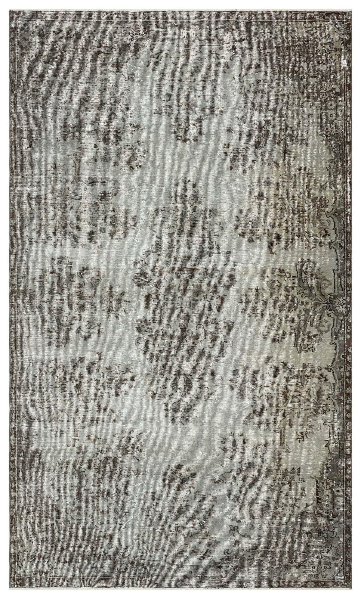 Distressed grey and brown rug with a faded traditional floral medallion pattern on a white background.
