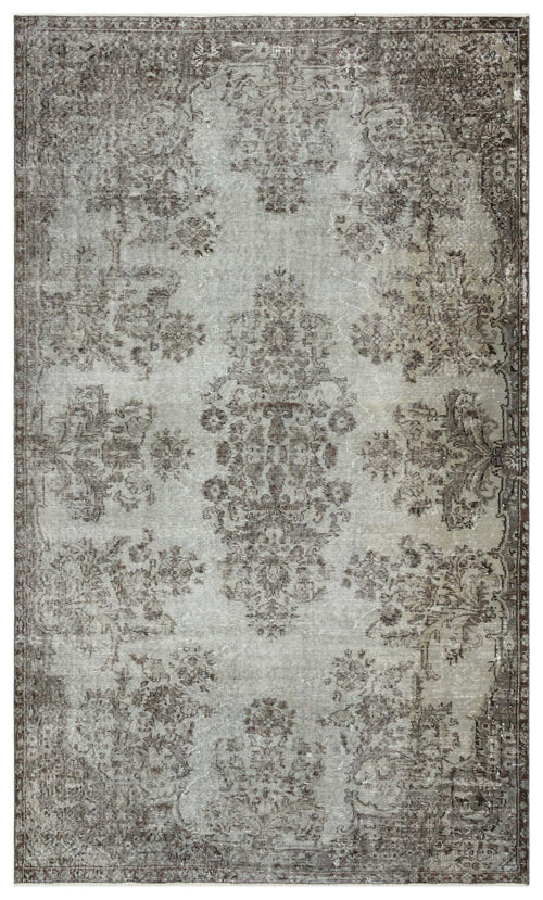 Load image 1 in gallery view. Distressed grey and brown rug with a faded traditional floral medallion pattern on a white background.