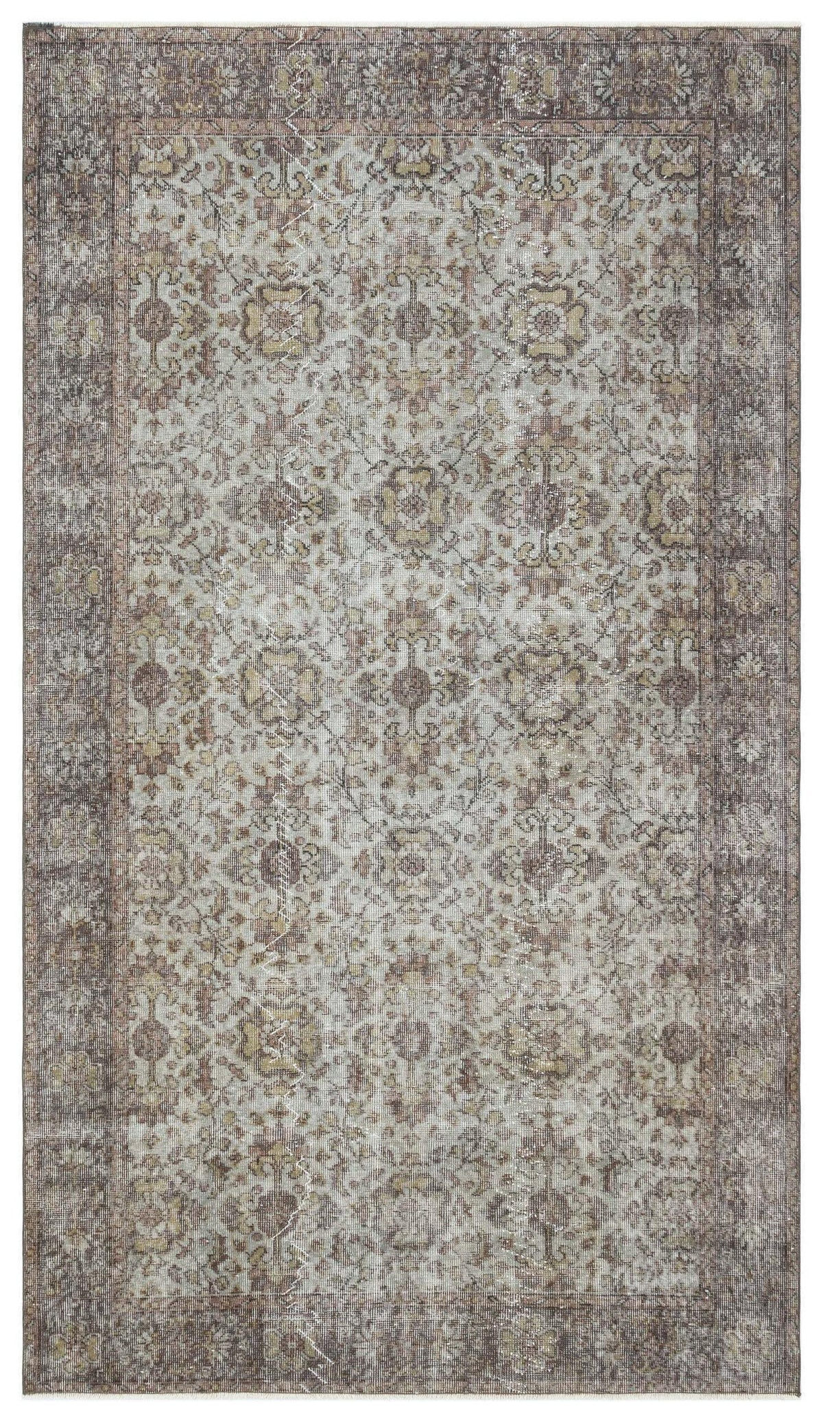 Distressed grey and brown traditional rug with a faded floral medallion pattern and a wide decorative border.