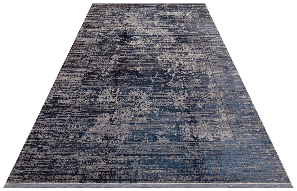 Navy blue and grey rectangular rug with a distressed, abstract textured pattern and a defined border.