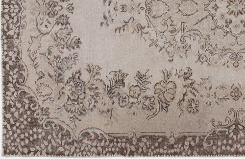 Load image 1 in gallery view. Beige and brown rug with a distressed floral medallion pattern and a detailed decorative border.