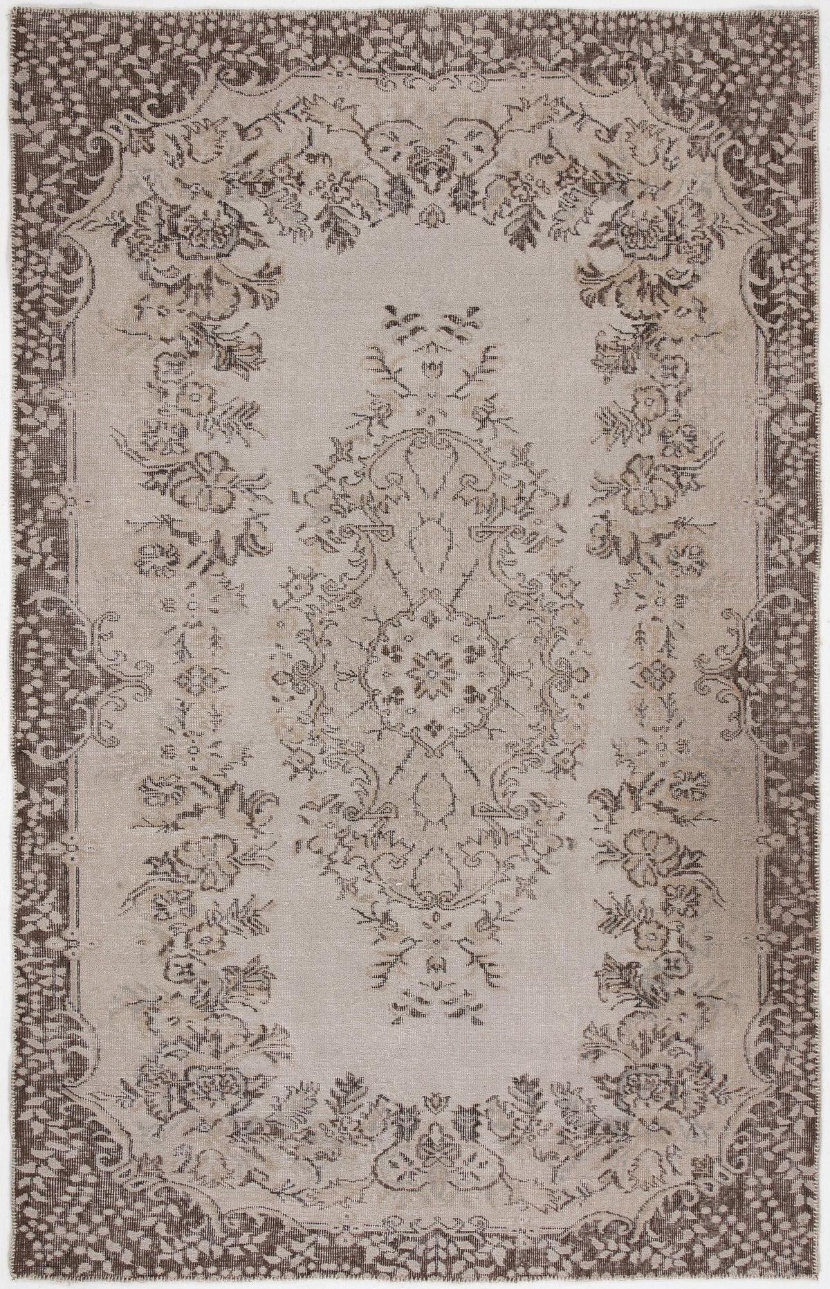 Beige and brown traditional rug with a central floral medallion and ornate border pattern on a white background.