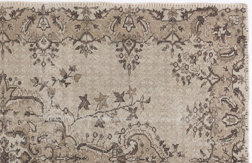 Load image 1 in gallery view. Beige and brown vintage-style rug with a distressed floral medallion pattern and a stitched edge.