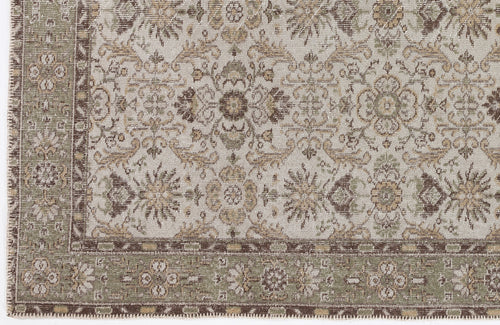 Load image 1 in gallery view. Beige, brown, and sage green traditional rug with a distressed floral medallion pattern and a decorative border.