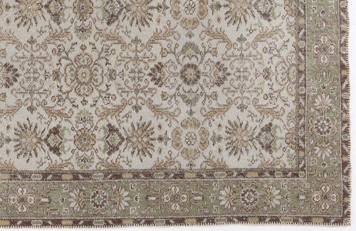 Load image 1 in gallery view. Distressed beige rug with a sage green and brown traditional floral medallion pattern and a decorative border.
