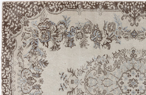 Load image 1 in gallery view. Beige, brown, and light blue traditional floral medallion rug with a distressed, vintage-inspired finish.