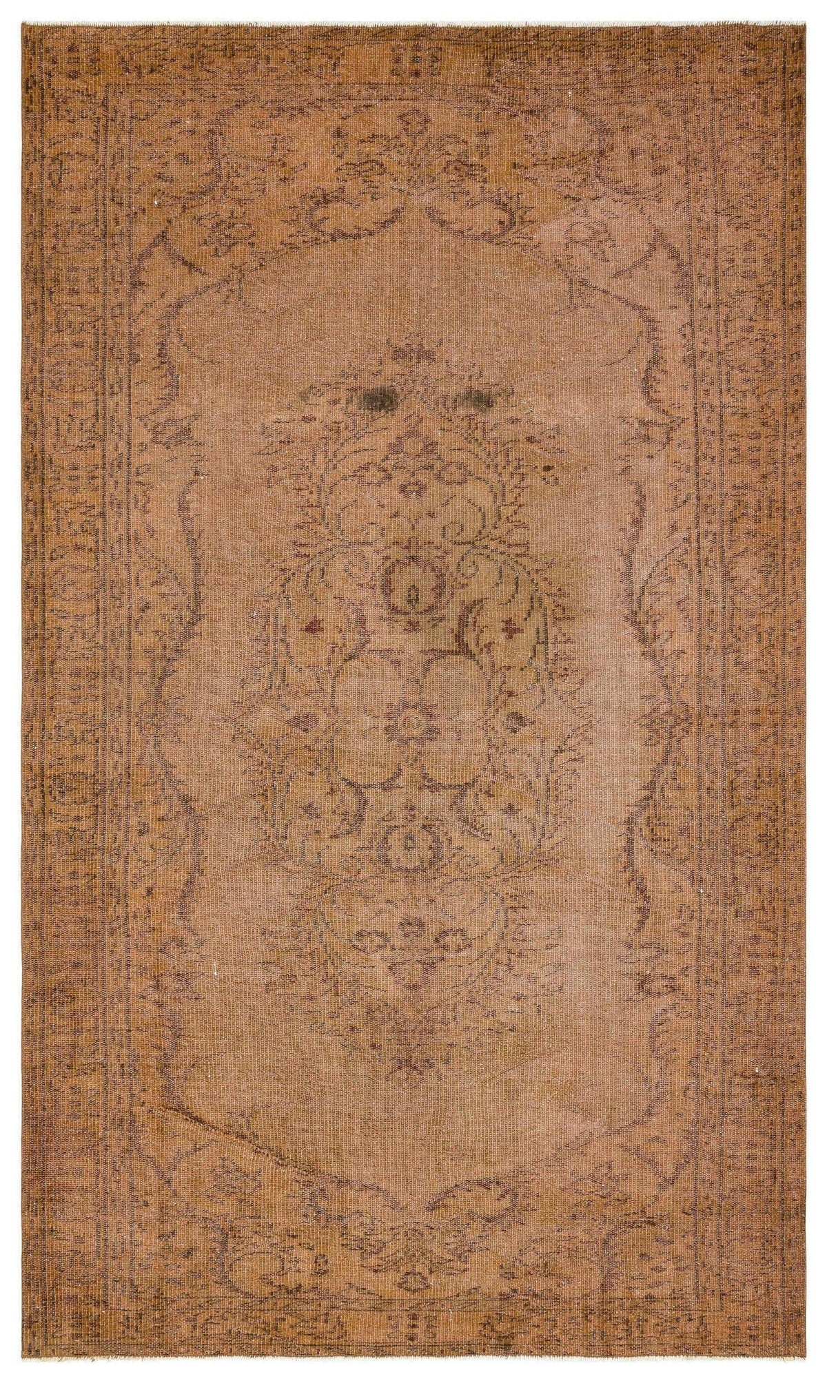 Distressed tan and brown rug with a central floral medallion and ornate border pattern.