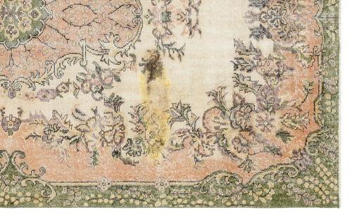 Load image 1 in gallery view. Distressed cream rug with a faded floral medallion pattern in muted peach, green, and charcoal on a white background.
