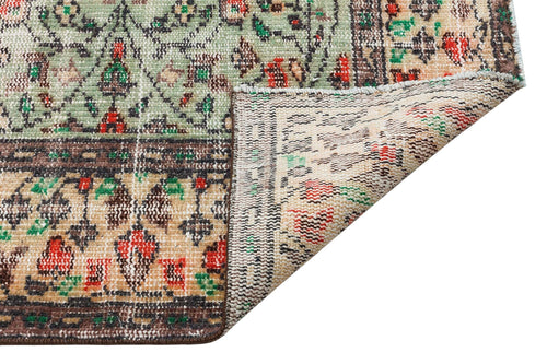 Load image 1 in gallery view. Sage green, beige, and red traditional floral rug with a folded corner revealing the woven backing.
