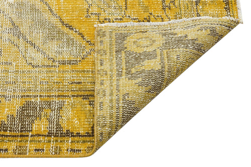 Load image 1 in gallery view. Mustard yellow and brown distressed traditional rug with a folded corner showing the woven backing.