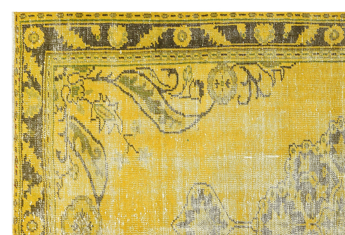 Mustard yellow and charcoal distressed rug with a traditional floral border and ornate medallion pattern.