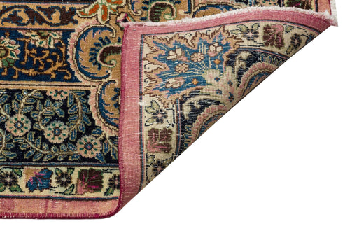 Load image 1 in gallery view. Traditional Persian-style rug with intricate floral patterns in blue, pink, and gold, shown with a folded corner.