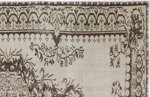 Load image 1 in gallery view. Beige and dark brown rug with a traditional geometric border and stylized floral motifs.