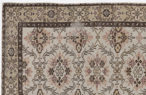 Load image 1 in gallery view. Beige, brown, and muted pink vintage-style rug with a floral medallion border and repeating botanical pattern.