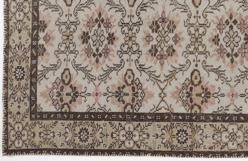 Load image 1 in gallery view. Beige rug with a brown and pink floral medallion pattern and a dark brown decorative border.