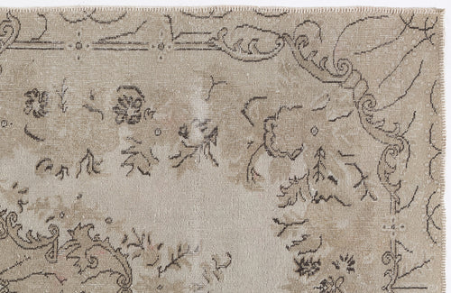 Load image 1 in gallery view. Beige vintage-style rug with a distressed, dark brown floral and scrollwork pattern on a white background.
