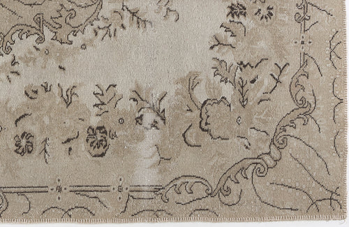 Load image 1 in gallery view. Beige and taupe distressed rug with a faded traditional floral and scrollwork pattern.
