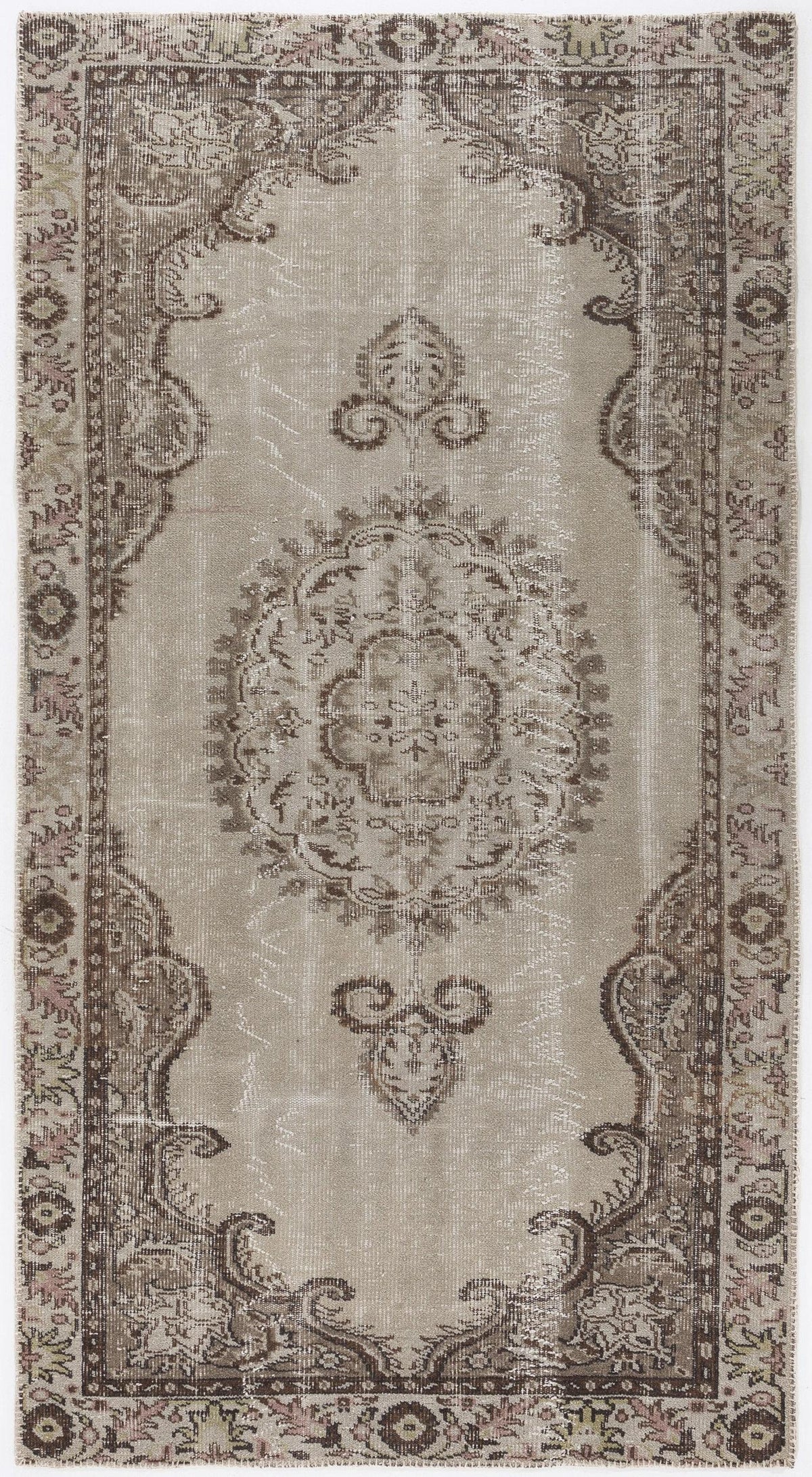 Taupe and brown vintage-style rug with a central floral medallion and ornate border on a white background.