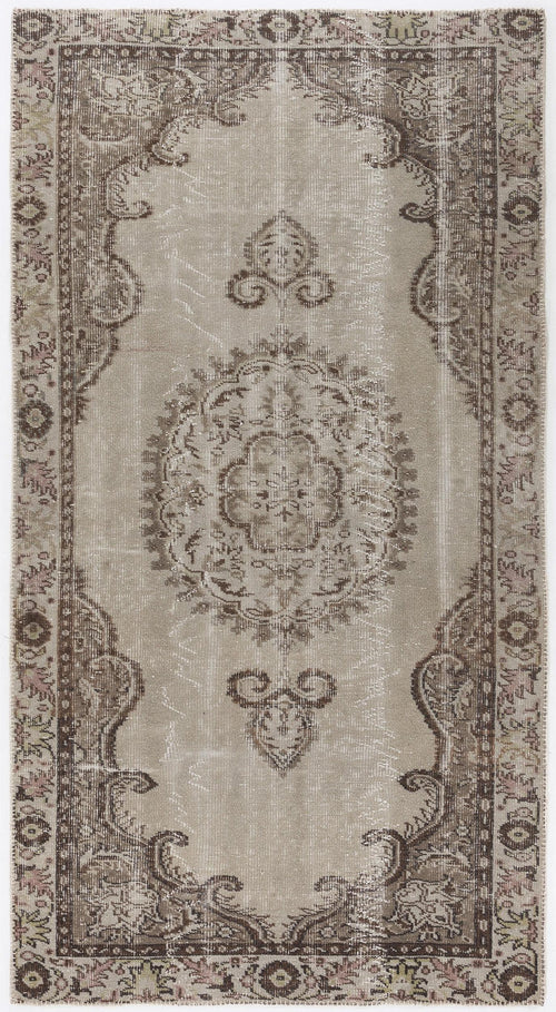 Load image 1 in gallery view. Taupe and brown vintage-style rug with a central floral medallion and ornate border on a white background.