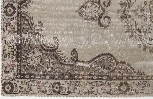 Load image 1 in gallery view. Taupe and brown distressed rug with a traditional ornate medallion pattern and faded vintage texture.
