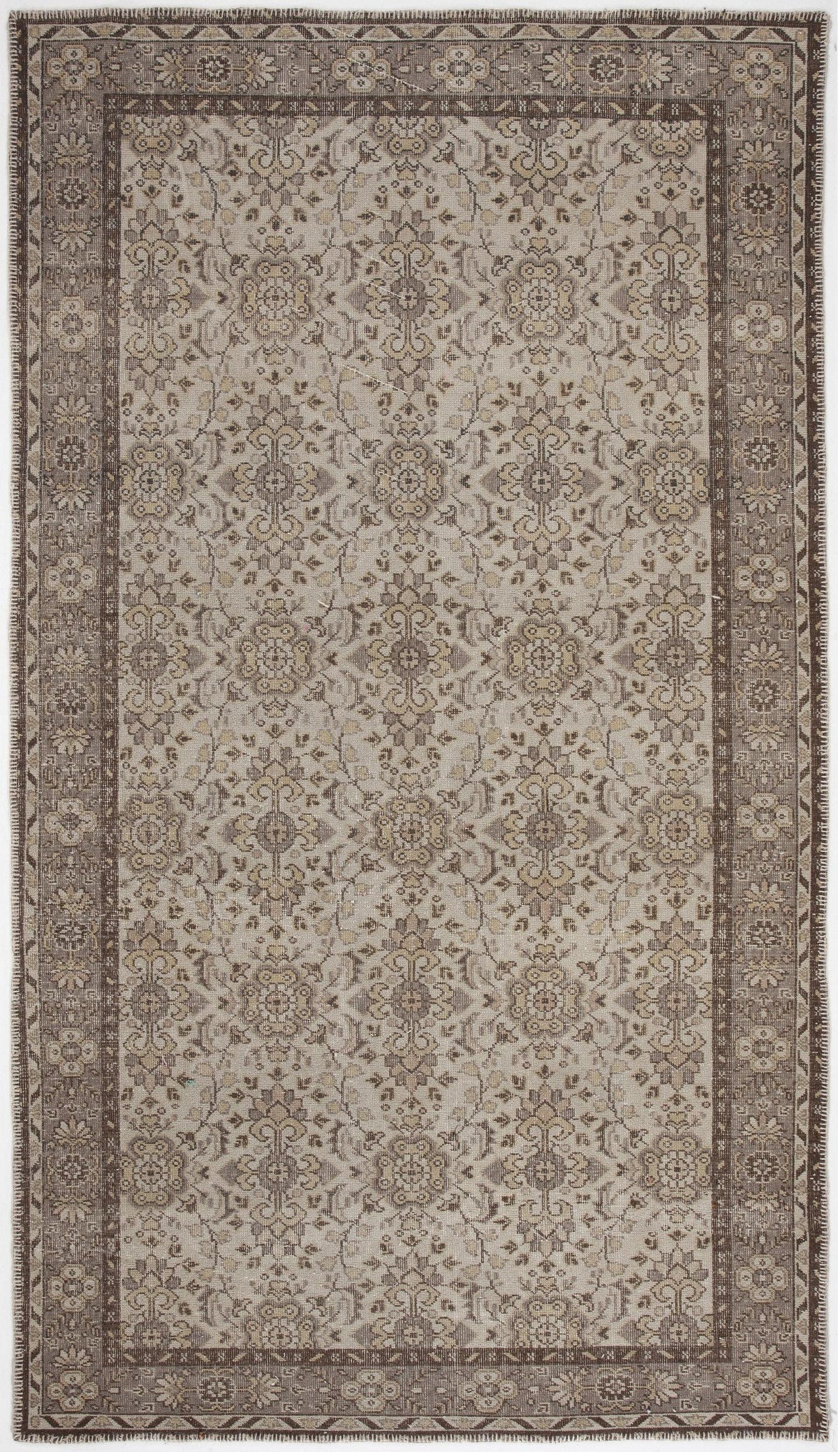 Taupe and beige traditional rug with a repeating floral medallion pattern and a wide, ornate border.