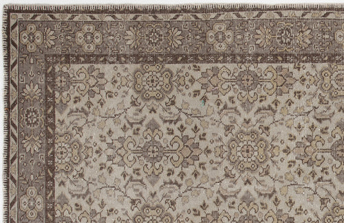 Load image 1 in gallery view. Brown and beige traditional rug with a distressed floral medallion pattern and a detailed geometric border.