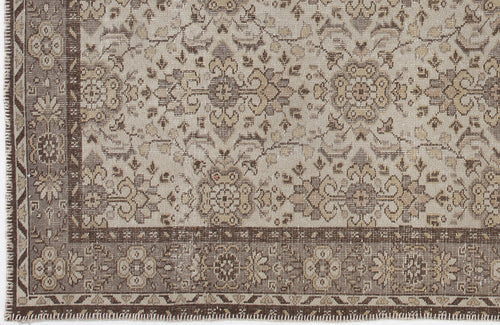 Load image 1 in gallery view. Beige and brown traditional rug with a distressed floral medallion pattern and a detailed geometric border.