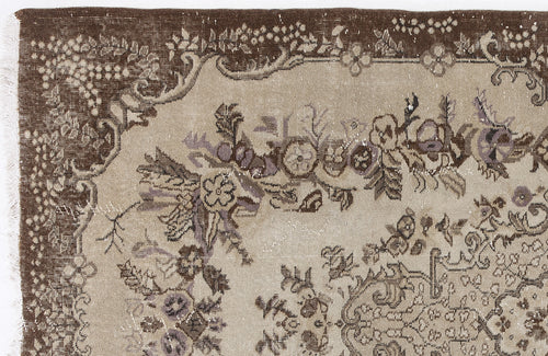 Load image 1 in gallery view. Distressed brown and beige rug with a traditional floral medallion pattern and a wide decorative border.