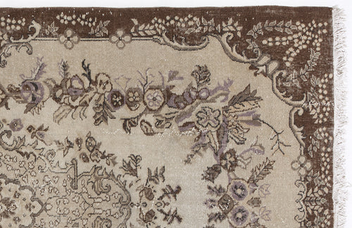 Load image 1 in gallery view. Brown and beige traditional rug with a distressed floral medallion pattern and fringed edge.