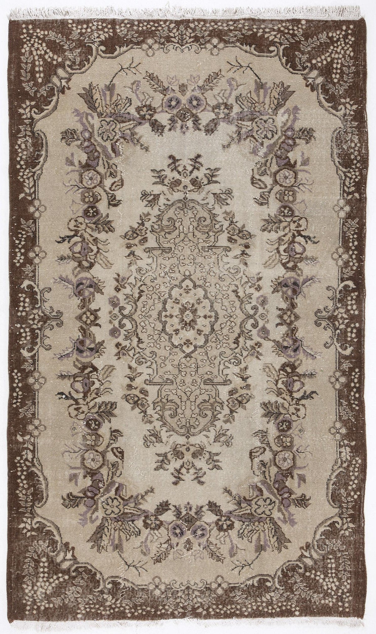 Beige and brown vintage-style rug with a central floral medallion and ornate botanical border, featuring fringe ends.