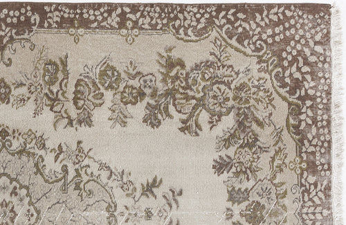 Load image 1 in gallery view. Beige and brown traditional rug with a floral medallion pattern and a fringed edge on a white background.