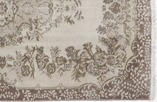 Load image 1 in gallery view. Beige and brown traditional rug with a distressed floral medallion pattern and fringed edge.