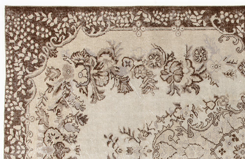 Load image 1 in gallery view. Brown and beige vintage-style rug with a floral medallion pattern and a decorative border.