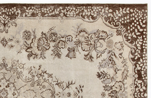 Load image 1 in gallery view. Beige and brown vintage-style rug with a distressed floral medallion pattern and a wide decorative border.