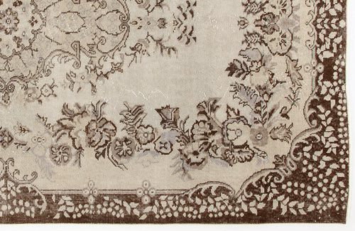 Load image 1 in gallery view. Beige and brown rug with a distressed floral medallion pattern and a decorative border.