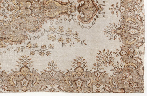 Load image 1 in gallery view. Beige and brown rug with a traditional floral medallion pattern and distressed texture.