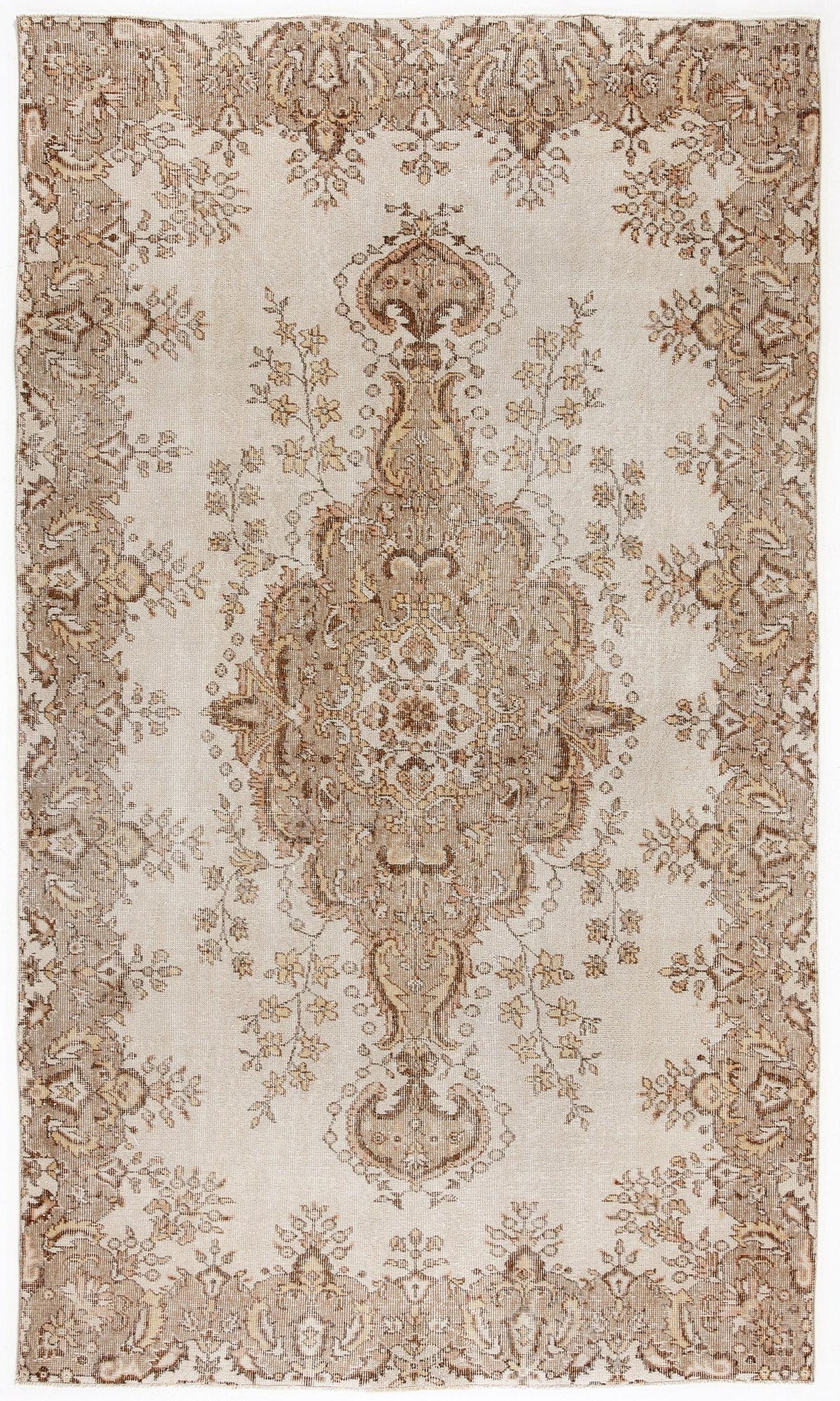 Beige and brown distressed rug with a central floral medallion and ornate border pattern.